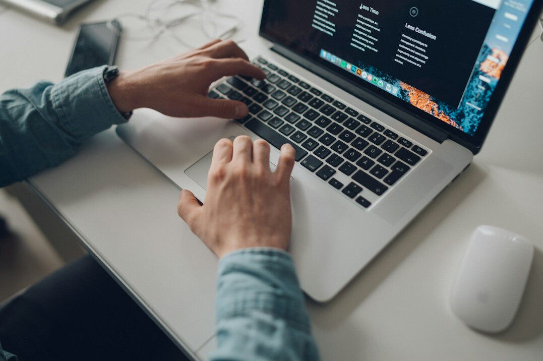 mystery writer typing on laptop