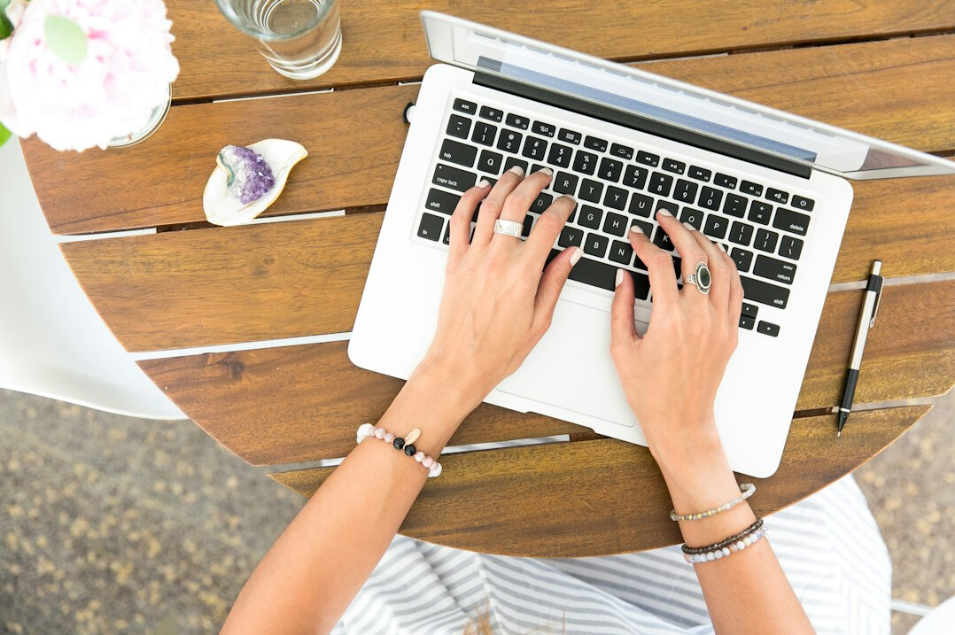 mystery writer typing on laptop